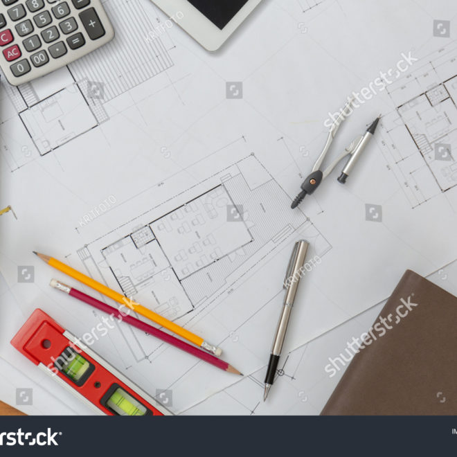 stock-photo-architect-desk-project-in-construction-site-with-blueprint-pen-tablet-computer-hardhat-construction-1343635742